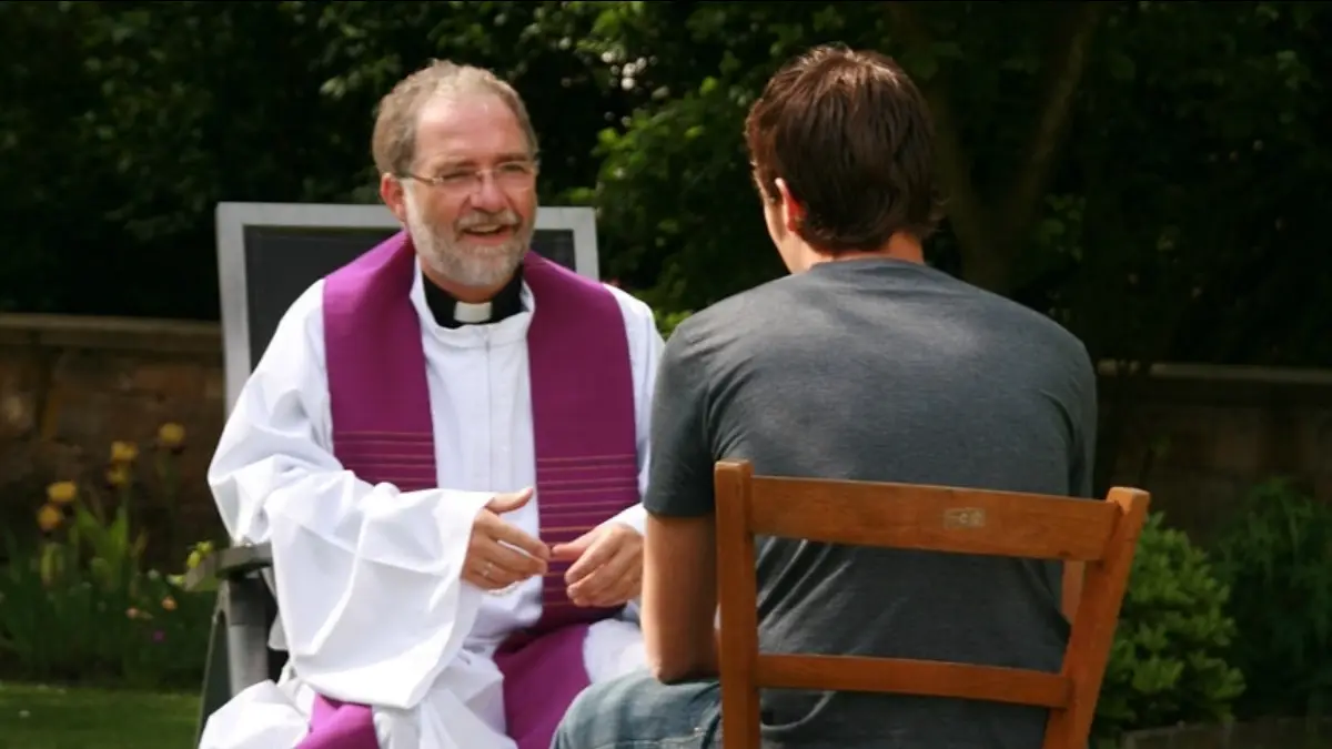 Un sacerdote confessa un giovane
